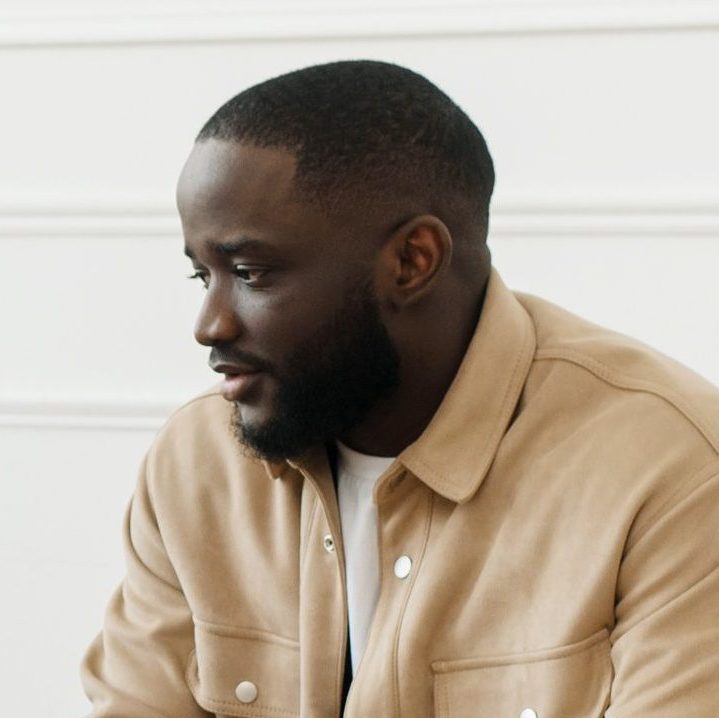 The therapist takes notes while talking to a depressed male patient and talks to an African American patient. Desperate black man suffering from nervous breakdown or depression having a session with a psychologist.